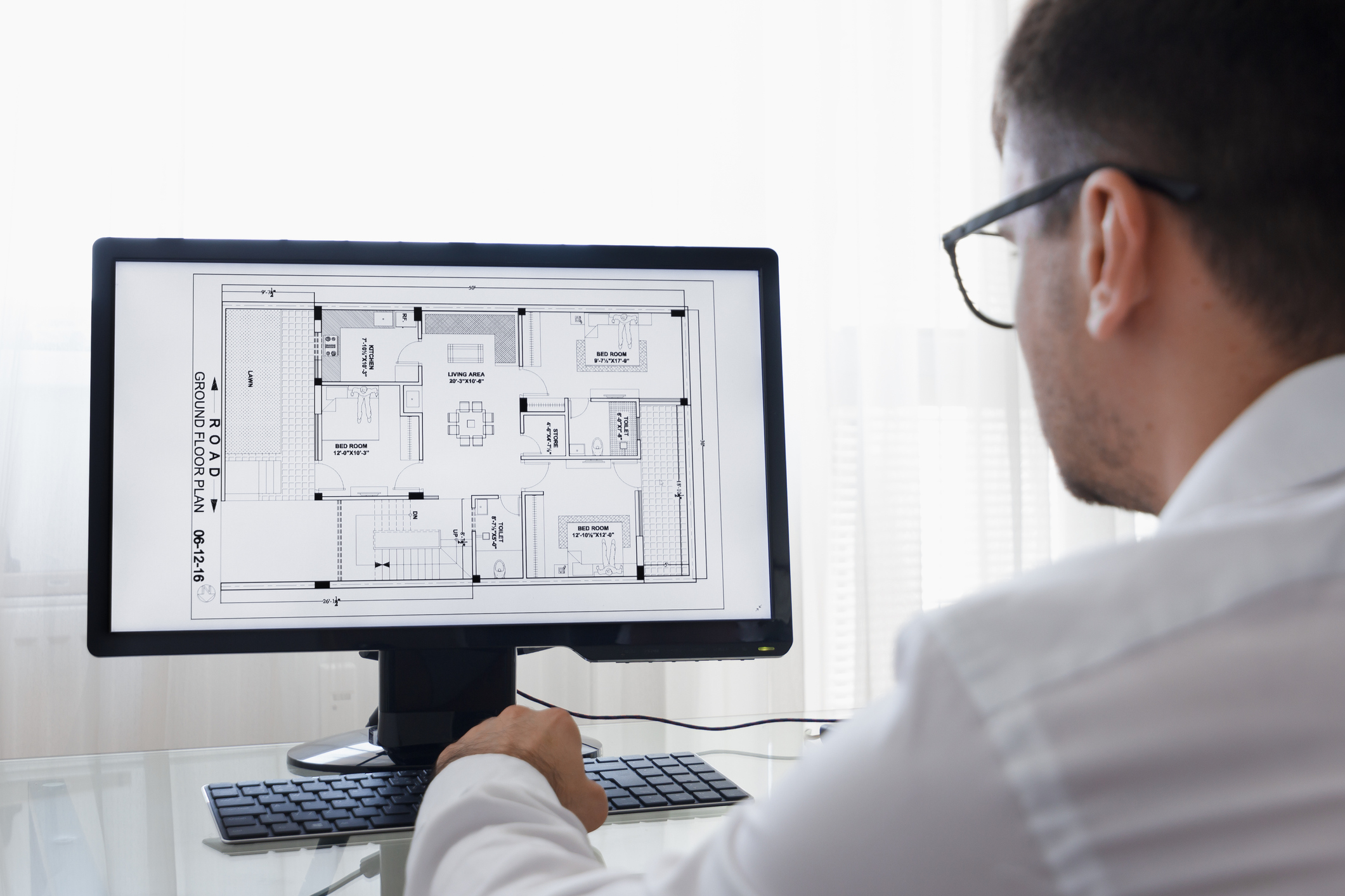 LOS ANGELES, CALIFORNIA - JUNE 3, 2019: Engineer, Constructor, Designer, Architect in Glasses Working on a Personal Computer. He Working With Building Blueprint on a Desktop. Freelance Work. An illustrative editorial image LOS ANGELES, CALIFORNIA - JUNE 3, 2019: Engineer, Constructor, Designer, Architect in Glasses Working on a Personal Computer. He Working With Building Blueprint on a Desktop. Freelance Work. An illustrative editorial image